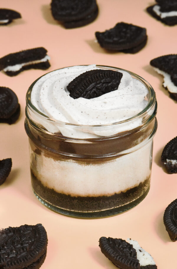 alt="Oreo cheesecake jar with an Oreo cookie crust, creamy Oreo cheesecake with cookie bits, layered with cookie butter crunch and topped with Oreo cream and cookie — made from scratch in San Antonio, Texas"