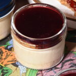 Peanut butter cheesecake on a graham cracker crust, layered with toasted milk bread and peanut praline crunch, topped with a smooth layer of house-made Concord grape jelly.