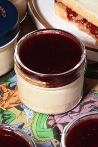 Peanut butter cheesecake on a graham cracker crust, layered with toasted milk bread and peanut praline crunch, topped with a smooth layer of house-made Concord grape jelly.