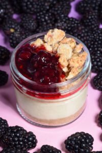 Vanilla cheesecake on a graham cracker crust with miso caramel filling, topped with house-made blackberry jam and burnt honey oat crumble. Made from scratch in San Antonio, Texas.